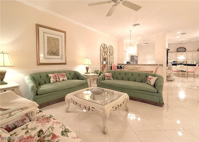 living room with ornamental molding, light tile patterned floors, and ceiling fan