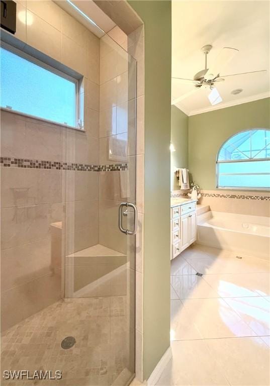 bathroom with ceiling fan, a healthy amount of sunlight, independent shower and bath, and vanity