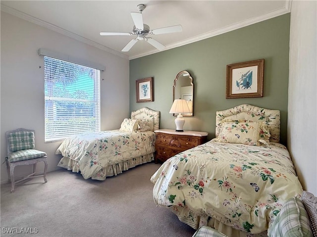 bedroom featuring ceiling fan, ornamental molding, and carpet floors