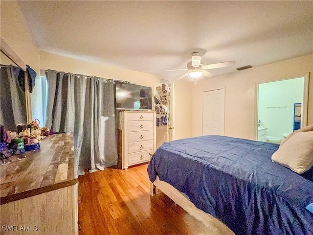 bedroom with connected bathroom, ceiling fan, and light wood-type flooring