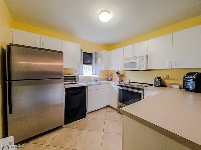 kitchen featuring light tile patterned flooring, stainless steel appliances, sink, and white cabinets