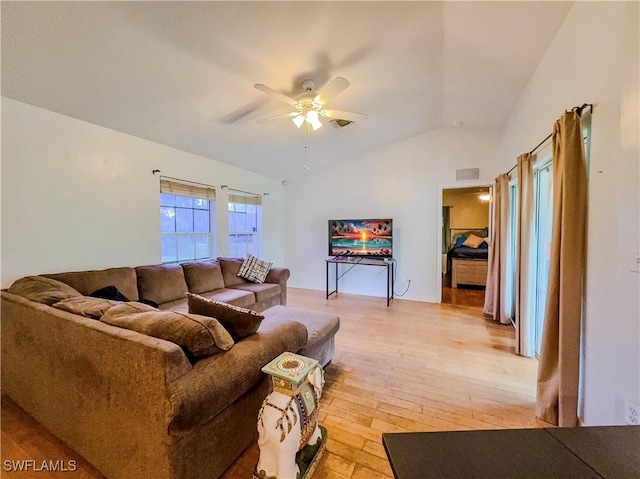 living room featuring ceiling fan, lofted ceiling, and light hardwood / wood-style floors