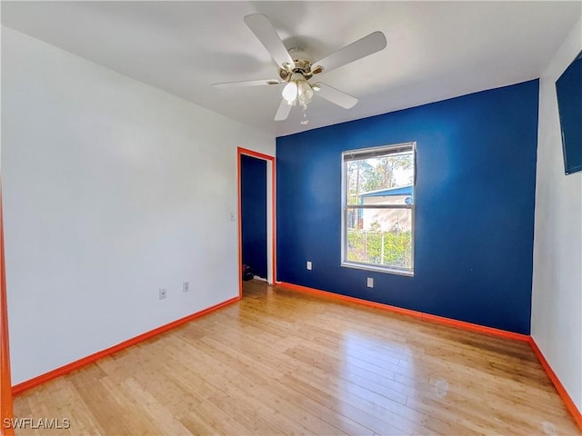 empty room featuring hardwood / wood-style floors and ceiling fan