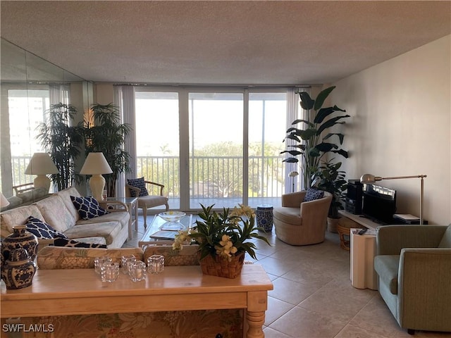 living room featuring light tile patterned floors, a wall of windows, and a textured ceiling