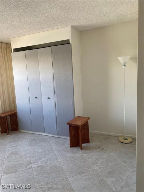 unfurnished bedroom with a closet and a textured ceiling