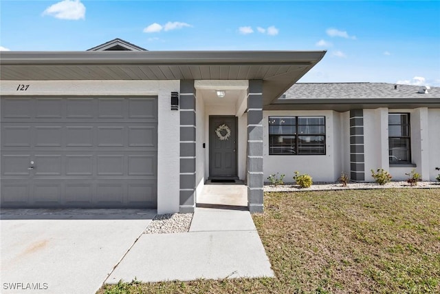 view of front of property featuring a garage and a front yard