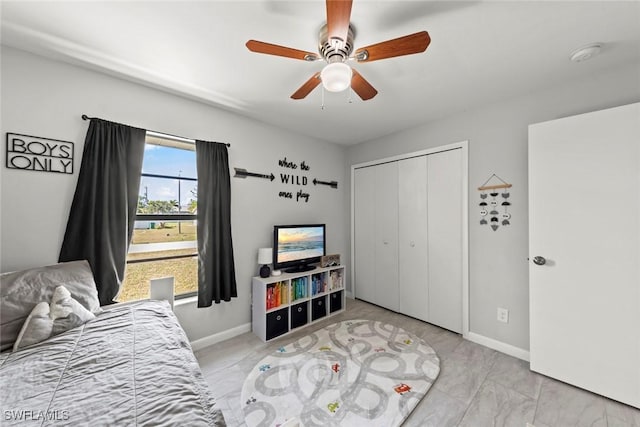 bedroom with ceiling fan and a closet