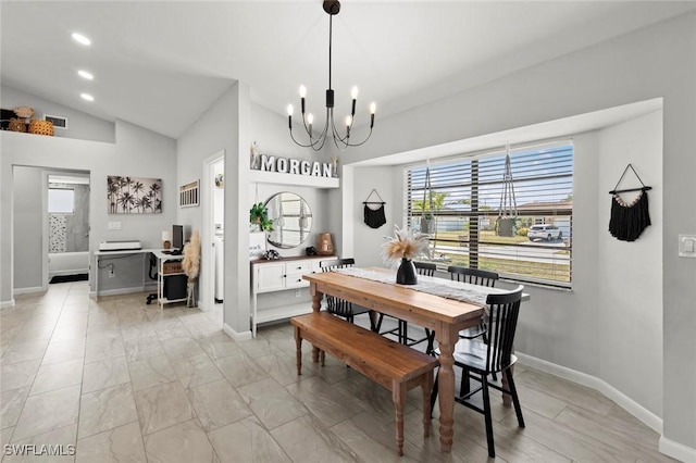 dining area with vaulted ceiling and an inviting chandelier