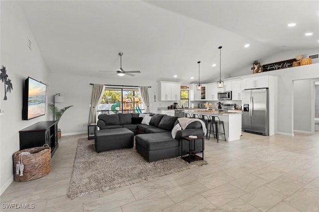 living room featuring ceiling fan and high vaulted ceiling