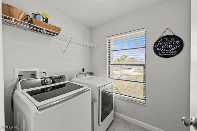 clothes washing area featuring separate washer and dryer