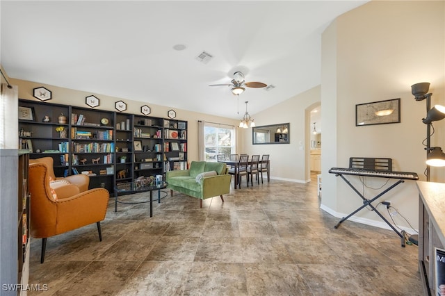 living area with ceiling fan and vaulted ceiling