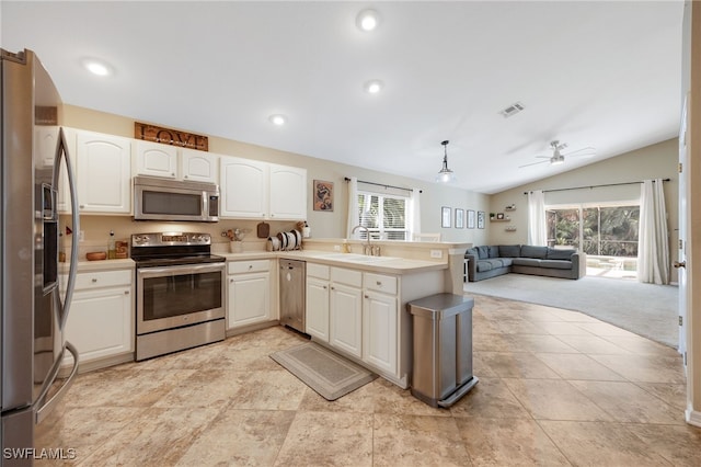 13404 Bristol Park Way, Fort Myers, FL 33913 - kitchen featuring stainless steel appliances, a peninsula, vaulted ceiling, open floor plan, and white cabinetry