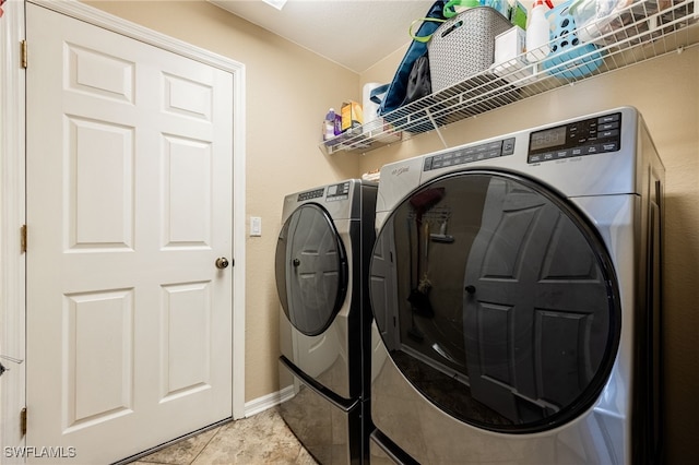 laundry area featuring light tile patterned floors and independent washer and dryer