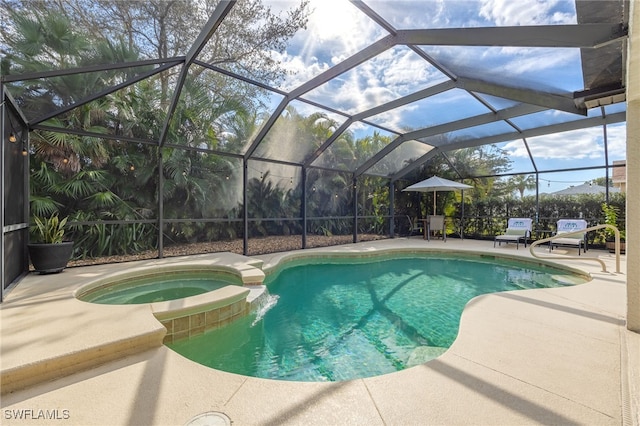 view of swimming pool with an in ground hot tub, a lanai, and a patio