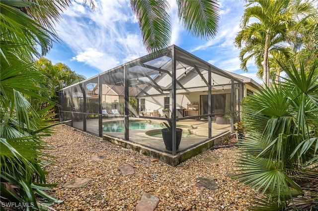 exterior space featuring a patio and glass enclosure