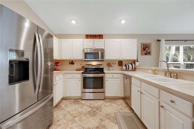 kitchen featuring white cabinetry, appliances with stainless steel finishes, and sink