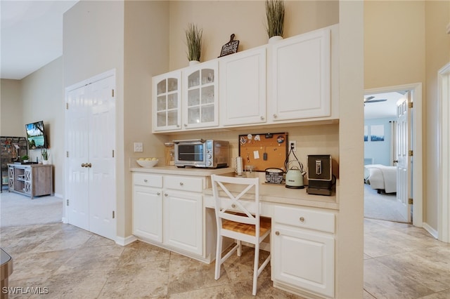 kitchen with a high ceiling and white cabinets