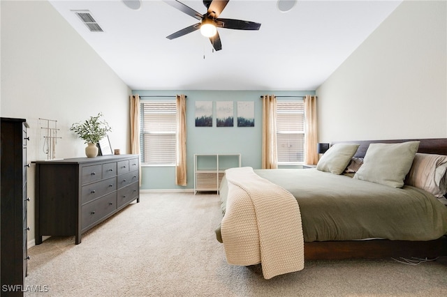 carpeted bedroom featuring multiple windows, vaulted ceiling, and ceiling fan