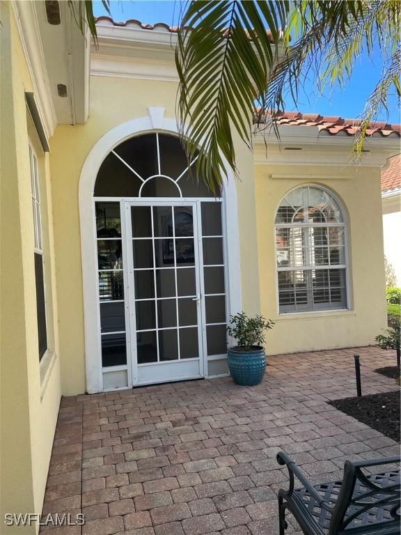 doorway to property with a patio area