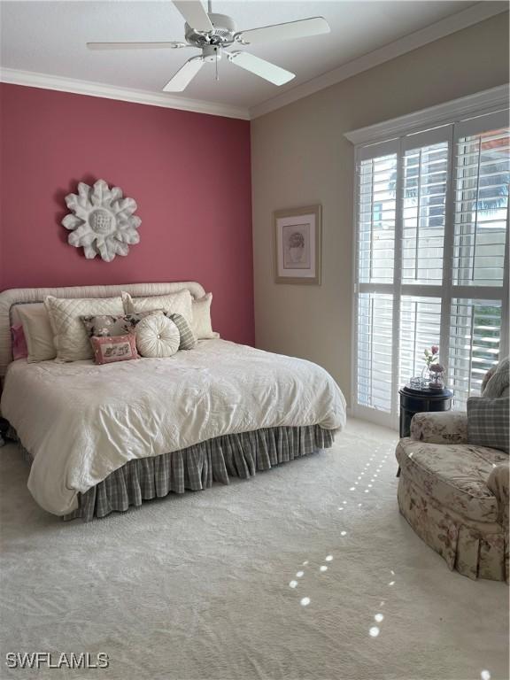 bedroom with ornamental molding, carpet floors, and ceiling fan