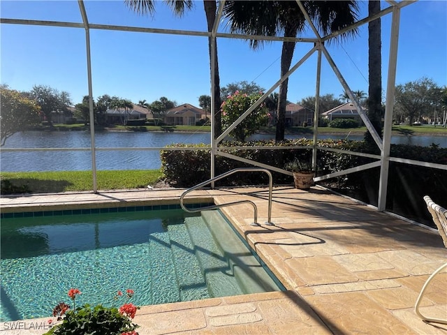 view of swimming pool with a water view, a patio, and glass enclosure