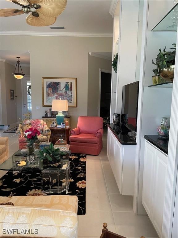 tiled living room with ornamental molding