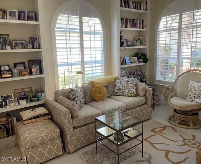 living area with tile patterned flooring and built in shelves