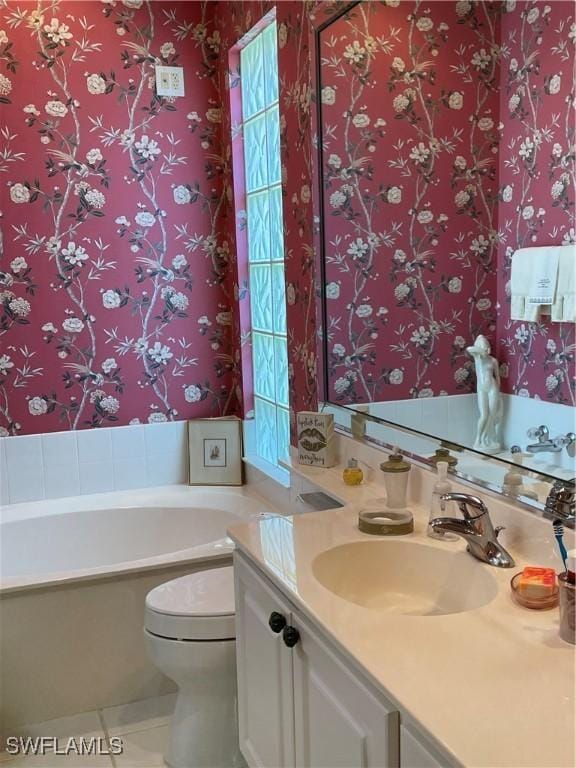 bathroom with vanity, toilet, tile patterned flooring, and a washtub