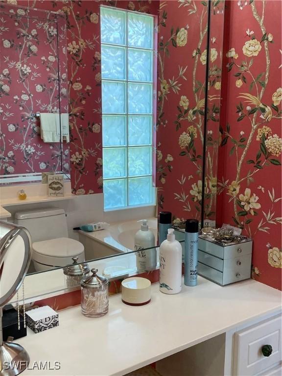 bathroom with plenty of natural light and toilet