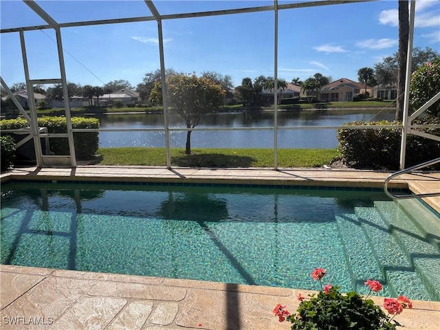 view of pool with a water view and glass enclosure