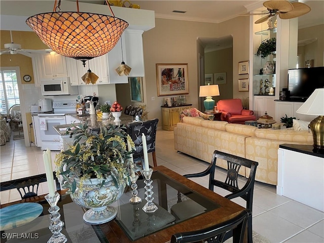 tiled dining room with crown molding, ceiling fan, and built in shelves