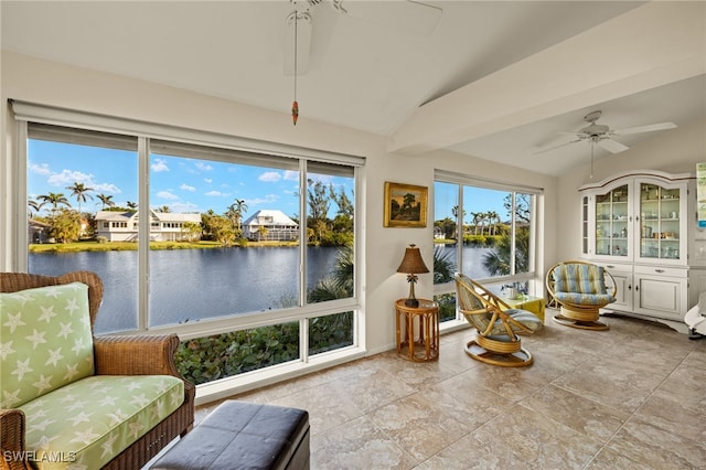 sunroom with a water view, ceiling fan, and vaulted ceiling