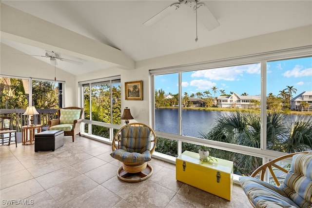 sunroom with lofted ceiling, ceiling fan, and a water view