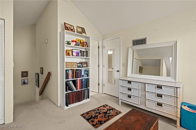 corridor with lofted ceiling, carpet flooring, visible vents, and an upstairs landing