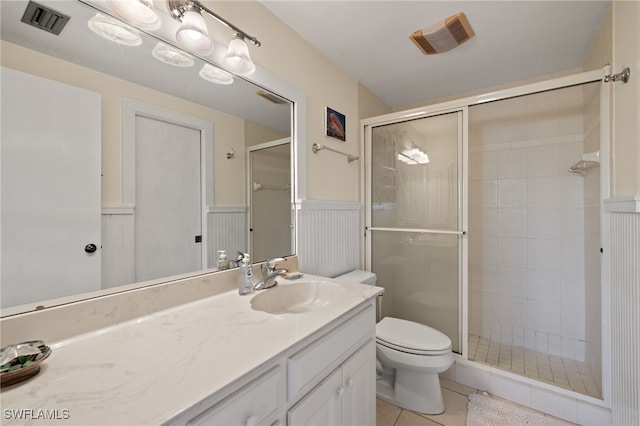 full bathroom with a wainscoted wall, tile patterned flooring, visible vents, and a stall shower