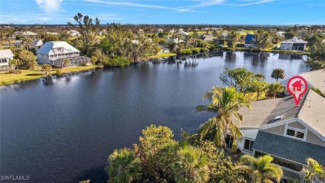 drone / aerial view featuring a residential view and a water view