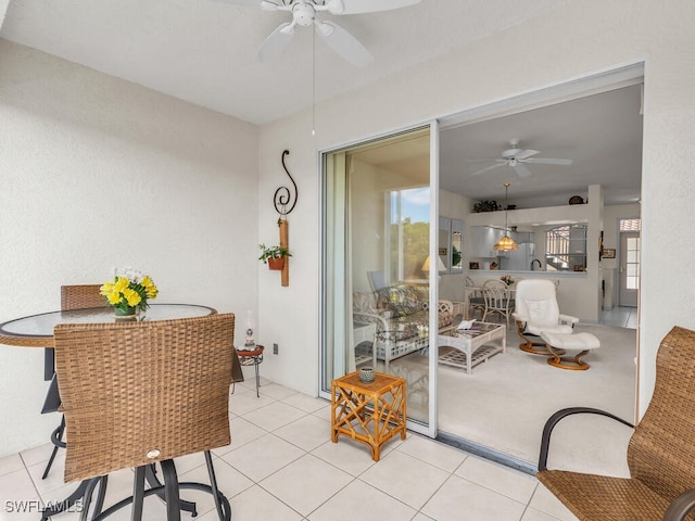 tiled living room featuring ceiling fan