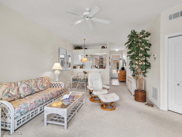 living room featuring ceiling fan and light colored carpet