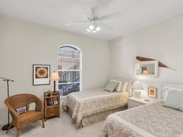 bedroom featuring light carpet and ceiling fan