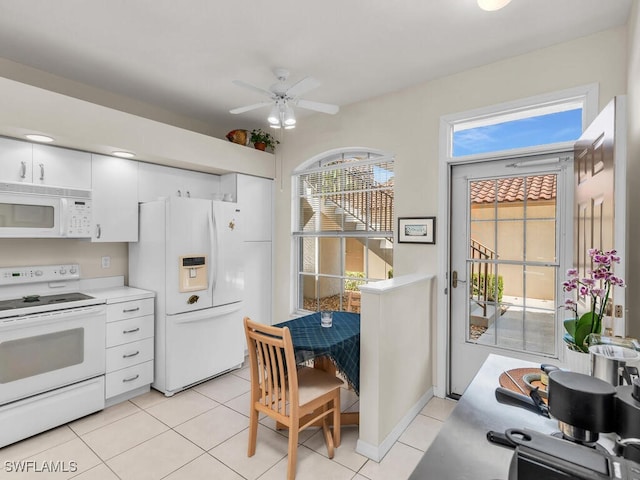 kitchen featuring light tile patterned flooring, ceiling fan, white cabinets, and white appliances