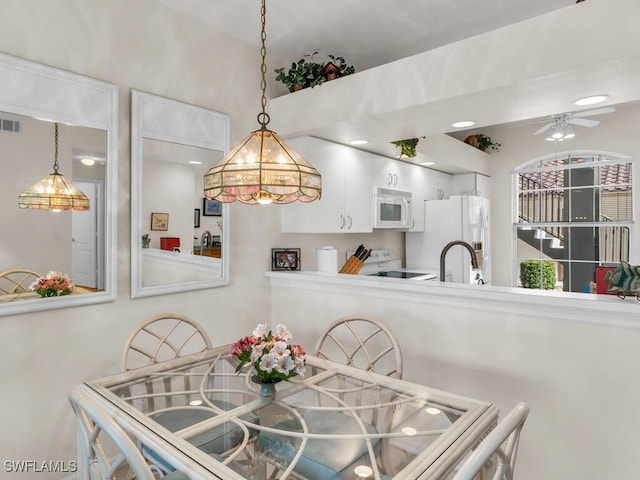 dining area featuring ceiling fan and sink