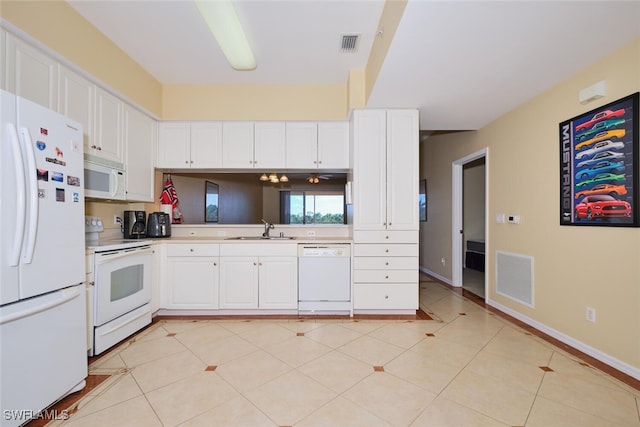 kitchen featuring sink, white appliances, and white cabinets