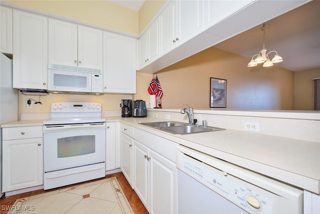 kitchen with sink, white cabinetry, decorative light fixtures, kitchen peninsula, and white appliances