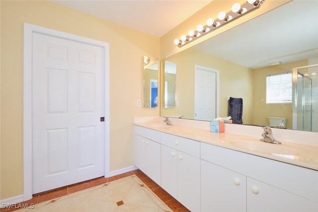 bathroom with vanity, a shower with door, tile patterned floors, and toilet