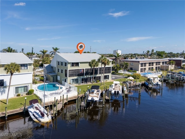 dock area with a water view and a pool