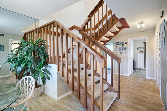 stairway featuring hardwood / wood-style floors