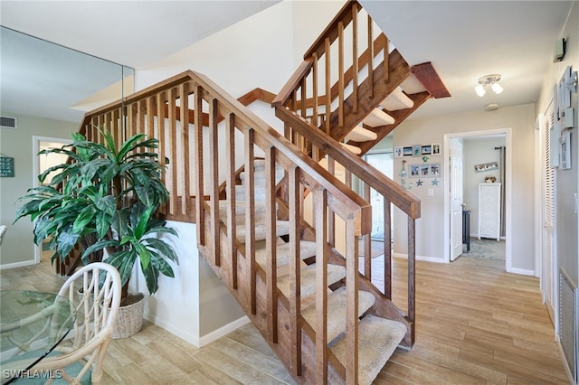 stairs featuring wood-type flooring