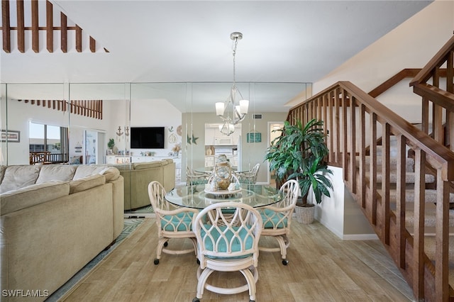 dining space featuring a notable chandelier and light hardwood / wood-style flooring