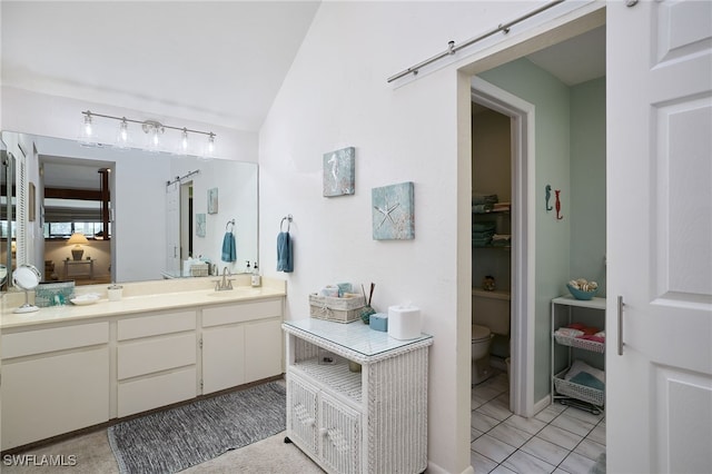 bathroom featuring vanity, tile patterned floors, and toilet