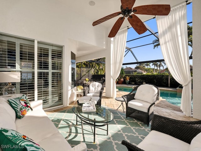 view of patio featuring a lanai, outdoor lounge area, and ceiling fan